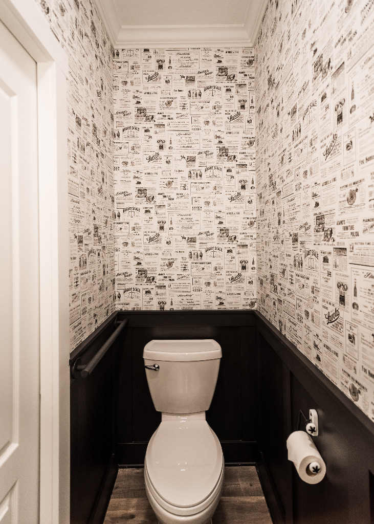 Lakehouse Bathroom separate toilet room decorated with newspaper-theme wallpaper by PH Design, custom construction and renovation company in Canton, OH