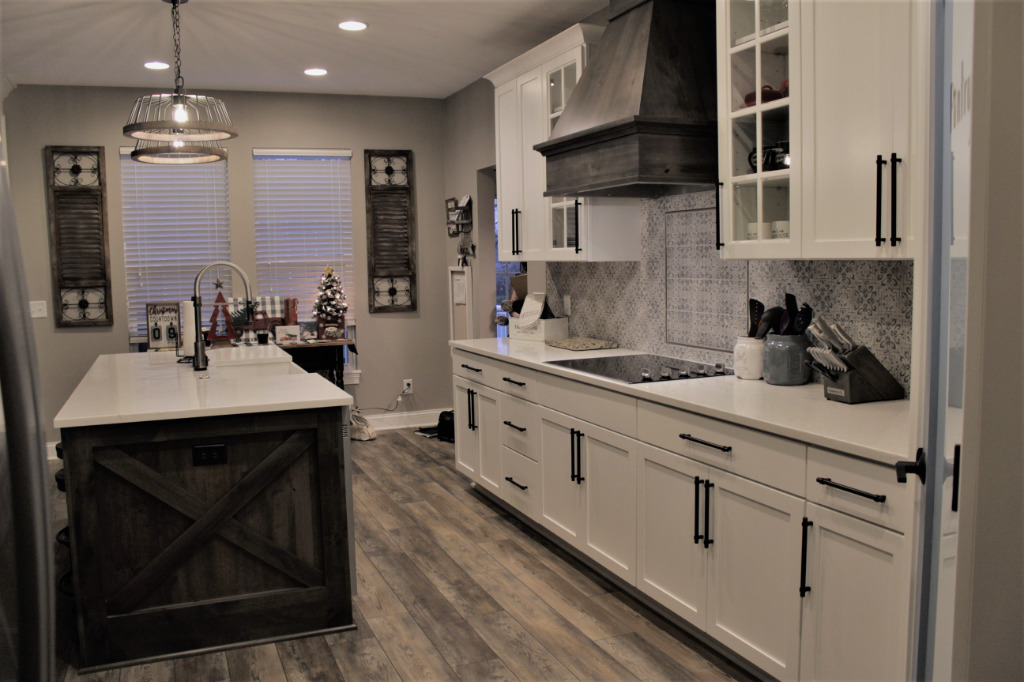 Farmhouse Kitchen renovation with modern kitchen fixtures and black and white cabinetry by PH Design, custom construction and renovation company in Canton, OH