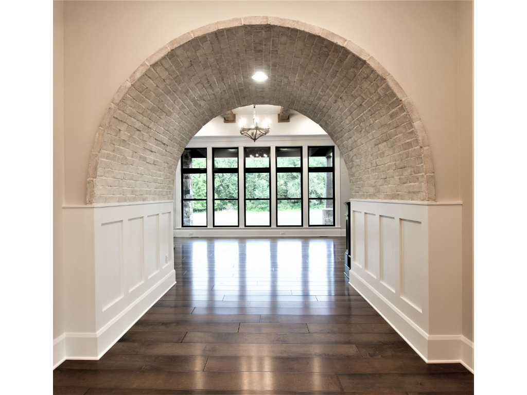 Entryway with arch of Woodford, tudor style home by PH Design, custom construction home builders in Canton, OH