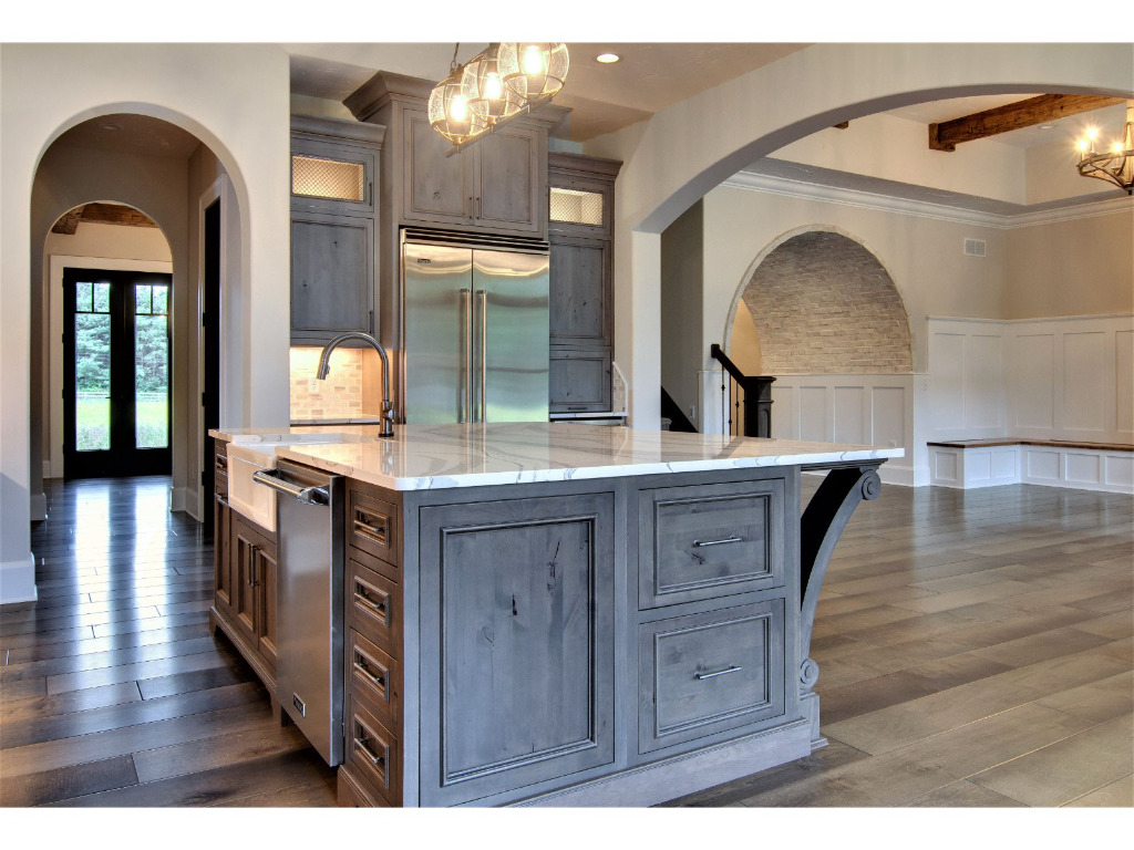 Kitchen island of Woodford, tudor style home by PH Design, custom construction home builders in Canton, OH