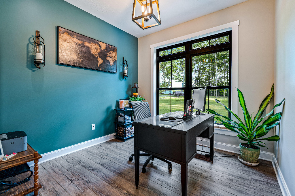 Furnished office with teal blue accent wall in Modern Craftsman style home by PH Design, custom construction home builders in Canton, OH