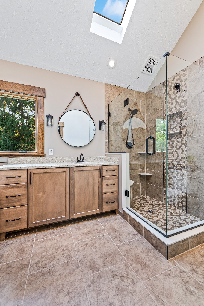 Rustic Bathroom renovation with tiled shower, granite vanity top, and wooden cabinetry by PH Design, custom construction and renovation company in Canton, OH