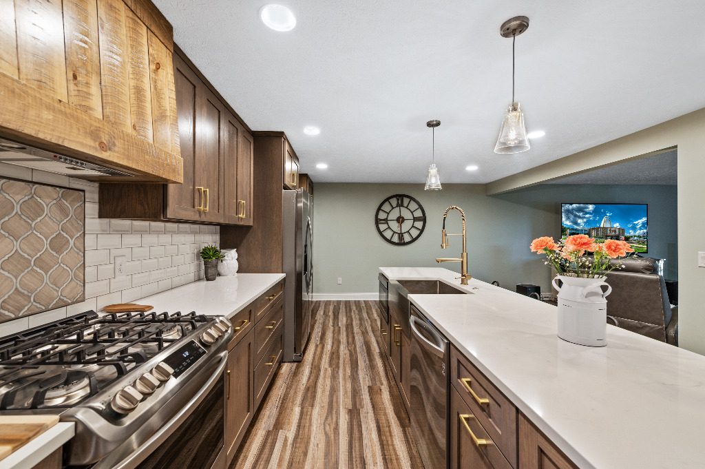 Eclectic Kitchen renovation with wooden cabinetry, hardwood floor, and tile backsplash by PH Design, custom construction and renovation company in Canton, OH