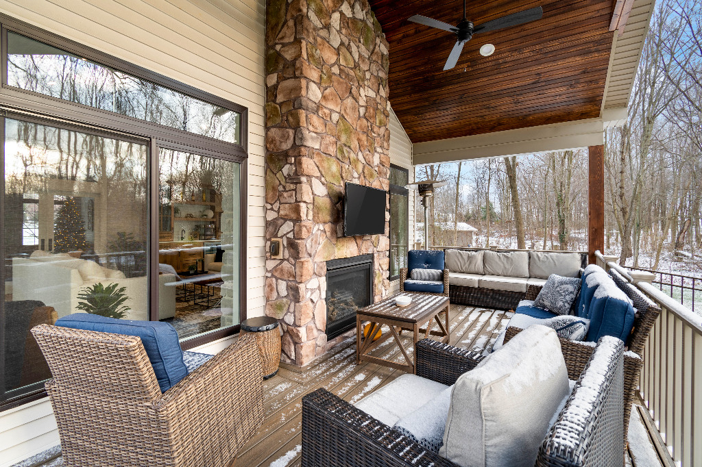 Furnished Sunroom with Double Sided Fireplace and Outdoor Space remodel by PH Design, home builders and custom home design and construction renovation company in Canton, OH