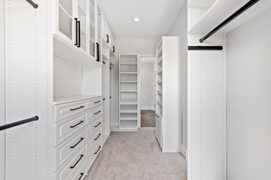 Master bedroom walk-in closet with extensive storage